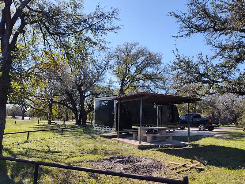 campsite with covered picnic tables at cedar creek campground, lake whitney, texas