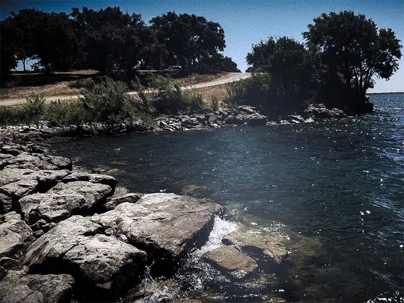 Photo of the shoreline at game warden slough at hubbard creek reservoir texas