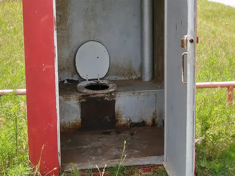 Photo of an old porta potty at joe benton park, lake nocona, texas