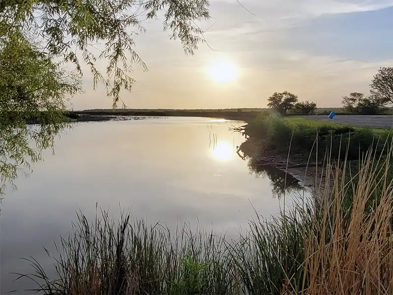 Photo of the sunset over the water at peeler park, hubbard creek reservoir, texas