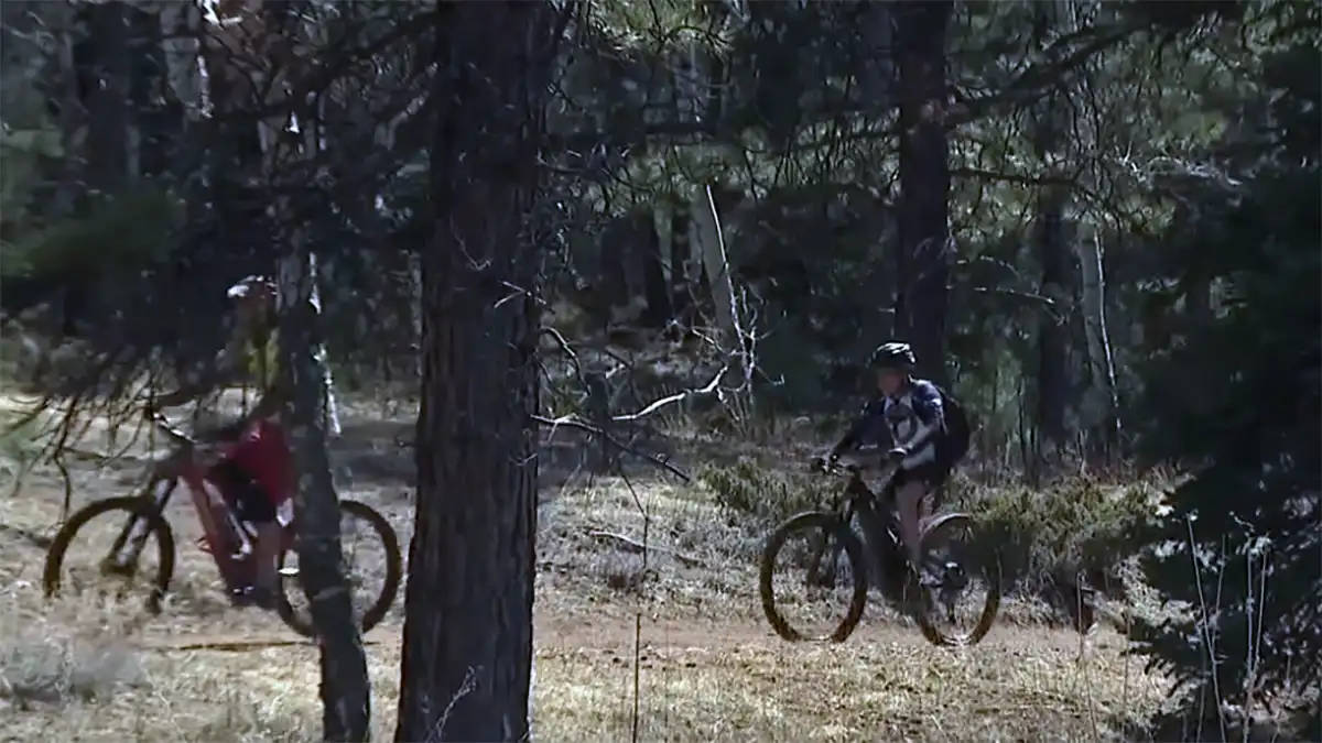 photo of two people riding e-bikes in a national park