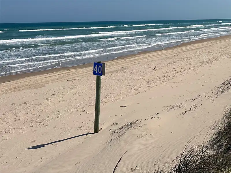 Photo of a mile marker at South Beach, Mile 5-60, Padre Island National Seashore